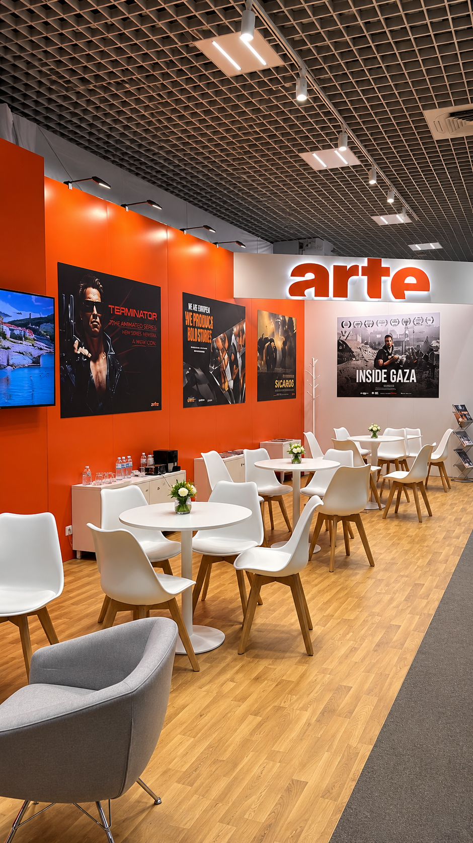 ARTE stand at MIPCOM Cannes 2026 with orange branding, programme displays and meeting tables